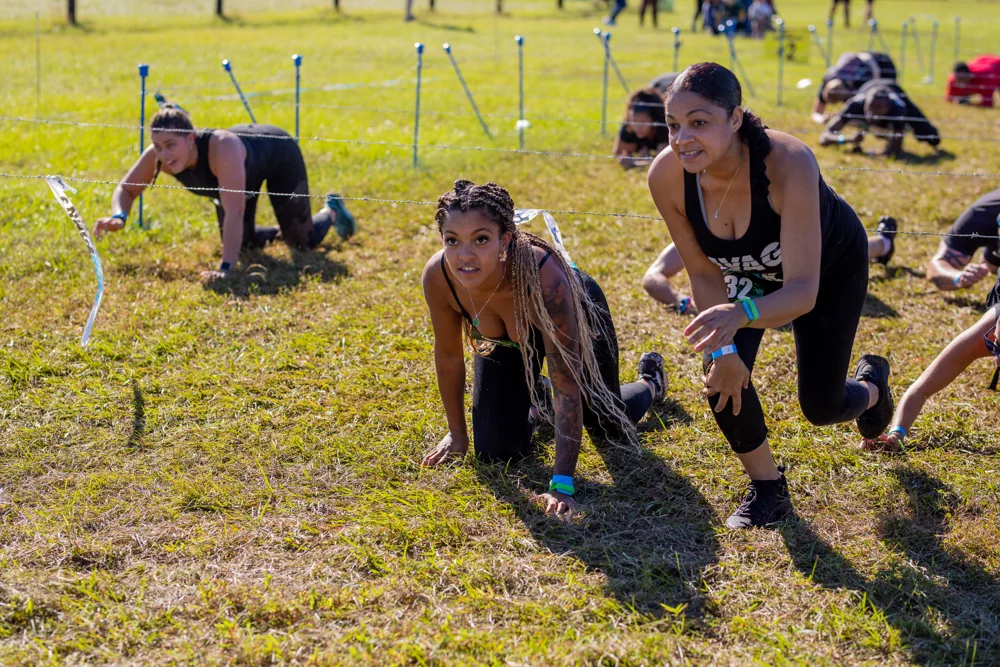 Two racers smile as they crawl under the wire