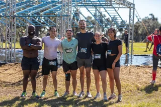 Friends smile together on the obstacle course
