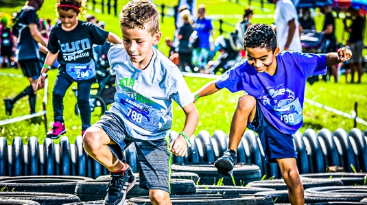 photo two kids competing in obstacle course