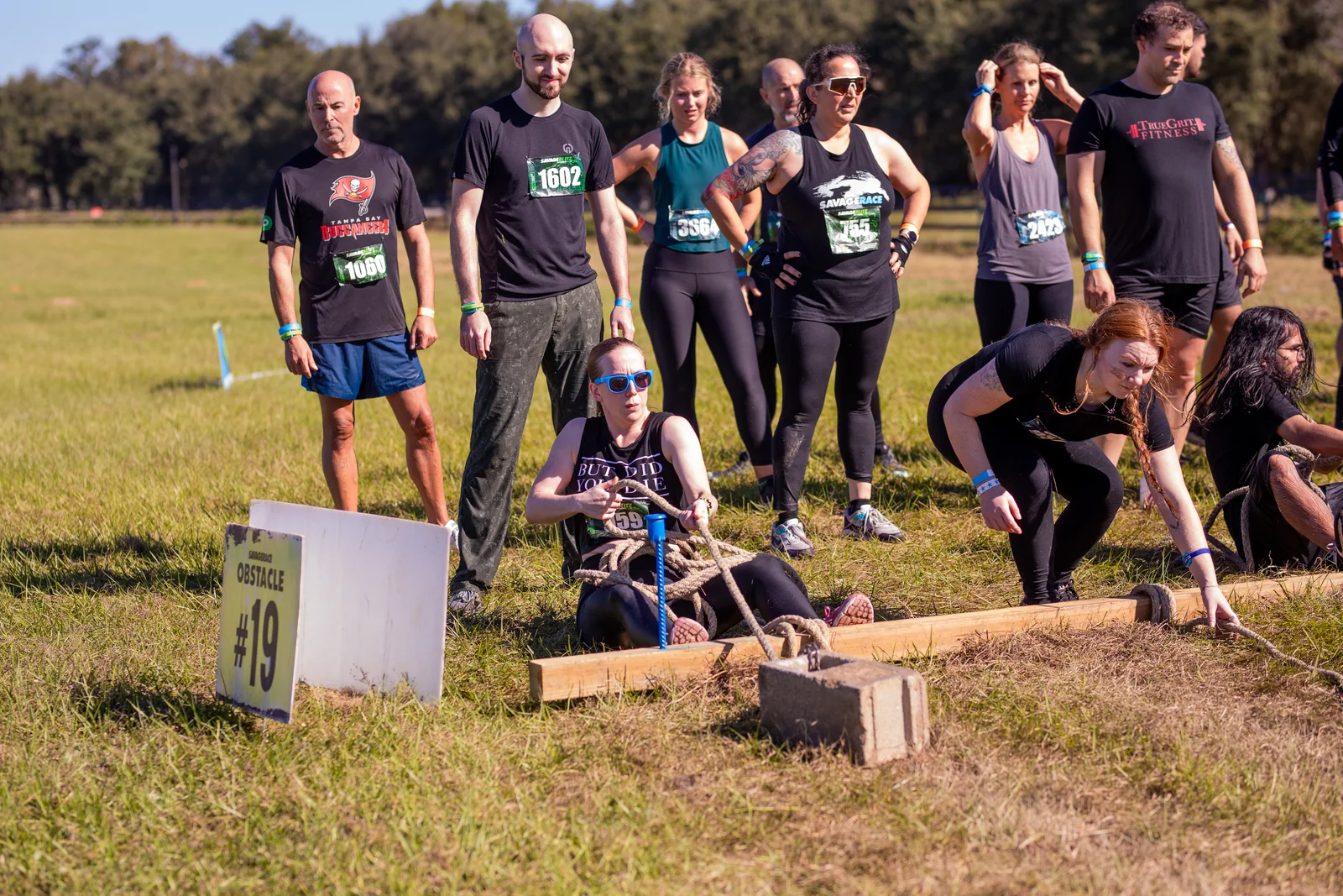 A team works together on a heavy sled pull