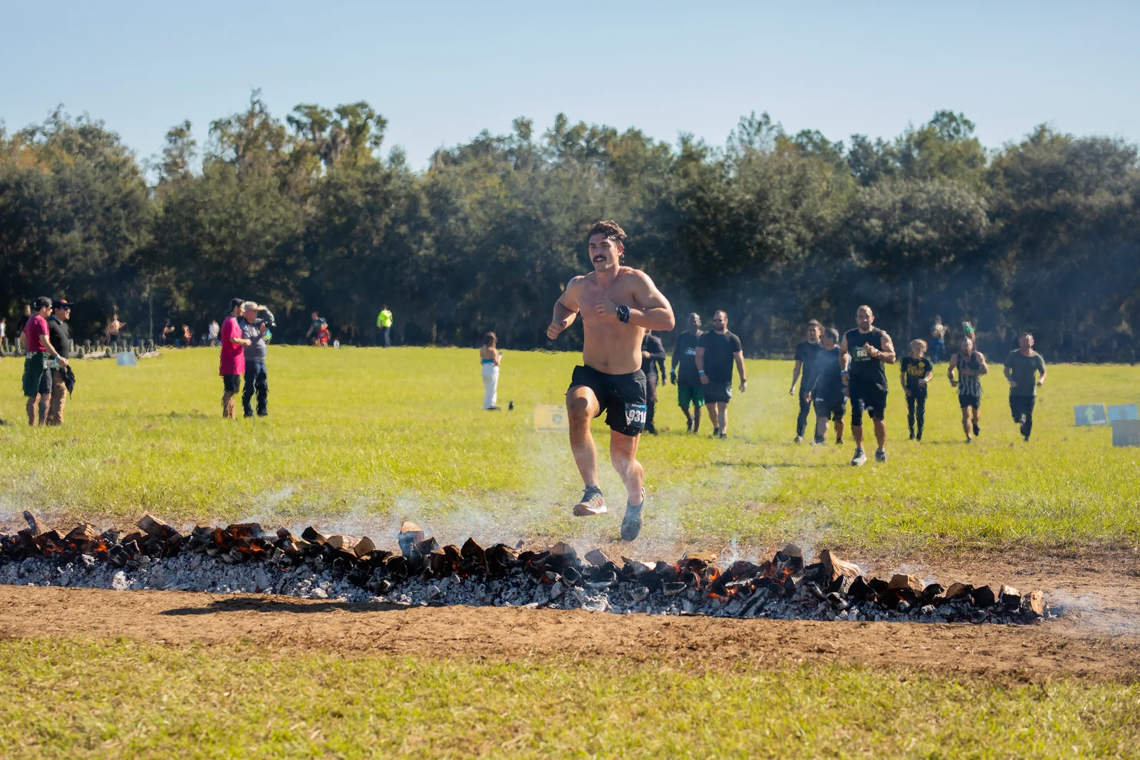 A racer jumps across the fire obstacle