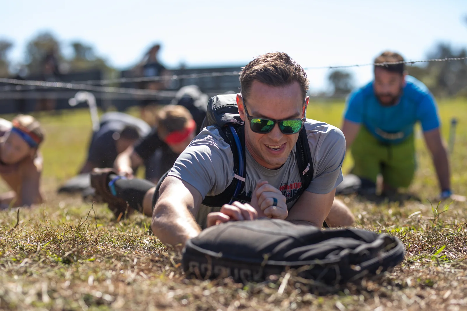 A smiling racer crawls under the wire