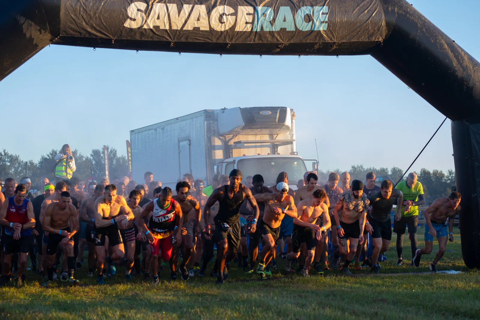 Racers set off together beneath the Savage Race starting arch